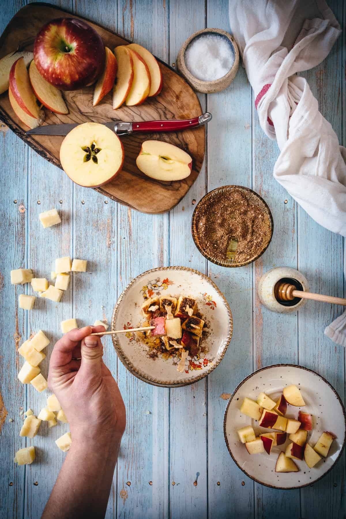 hand taking apple cheddar spear