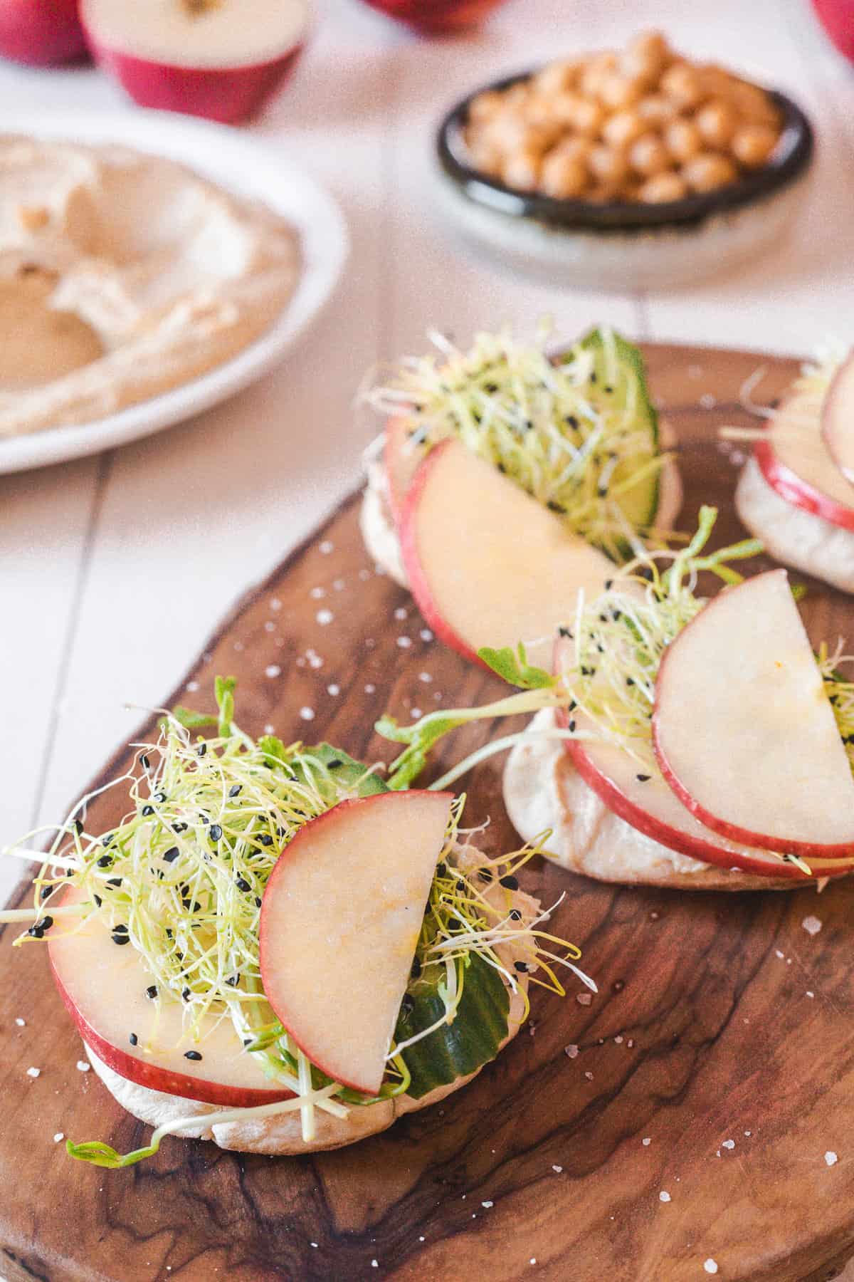 close up of apple hummus pitas on cutting board