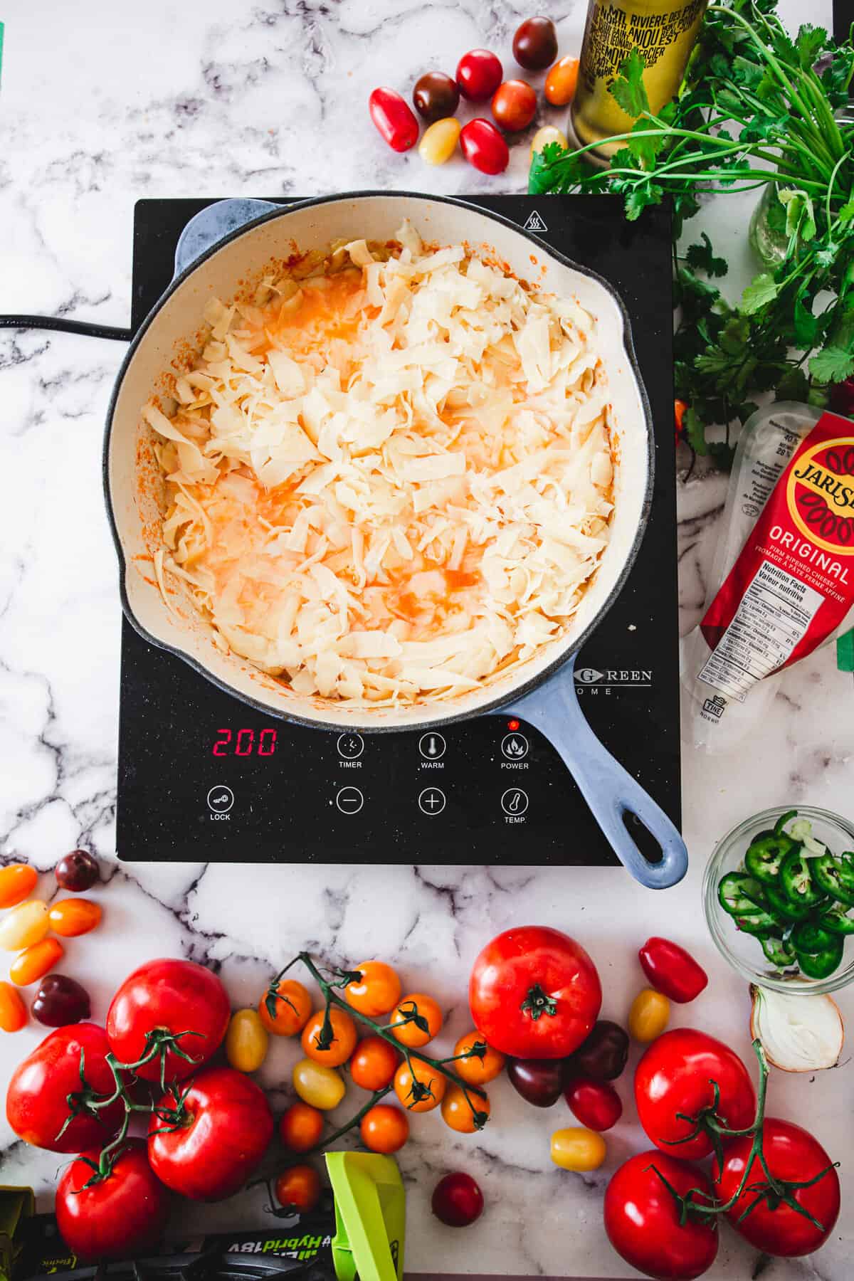 adding cheese to cheese shakshuka