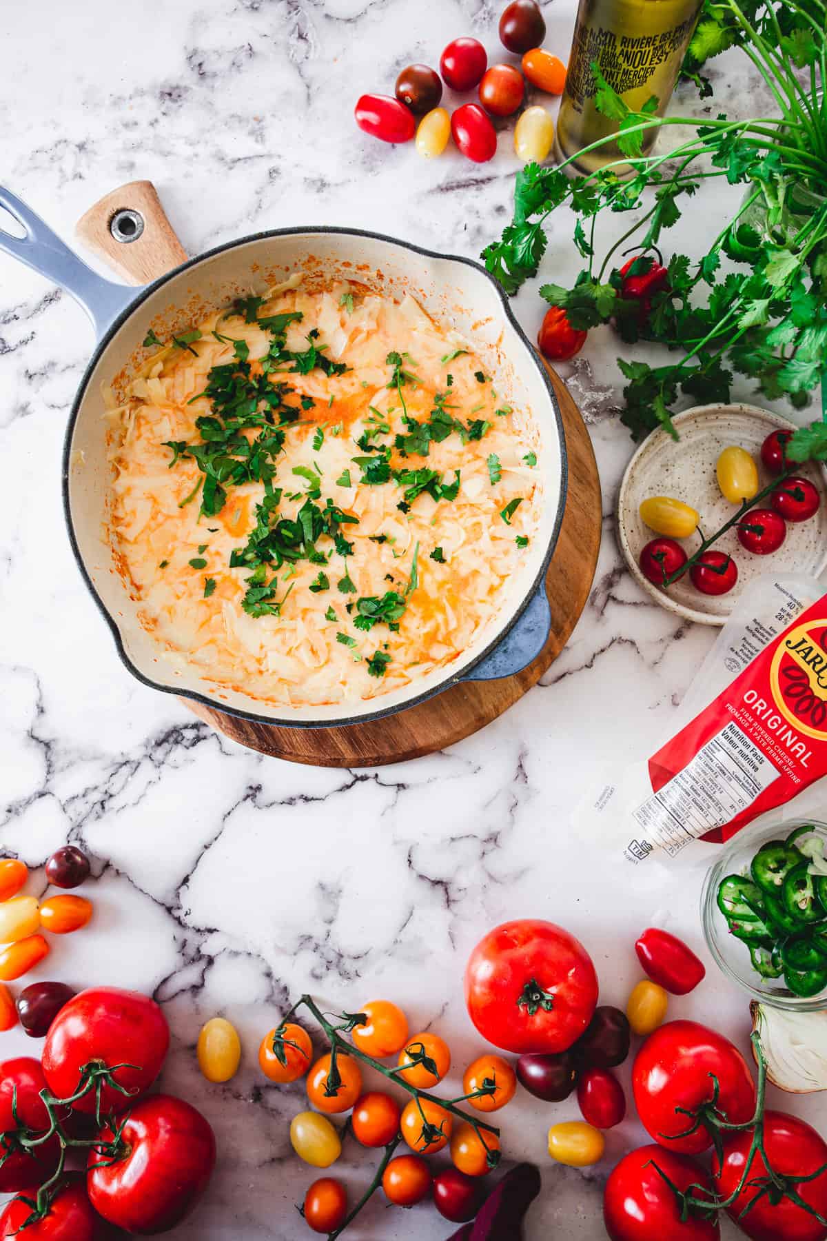 adding cilantro to cheese shakshuka