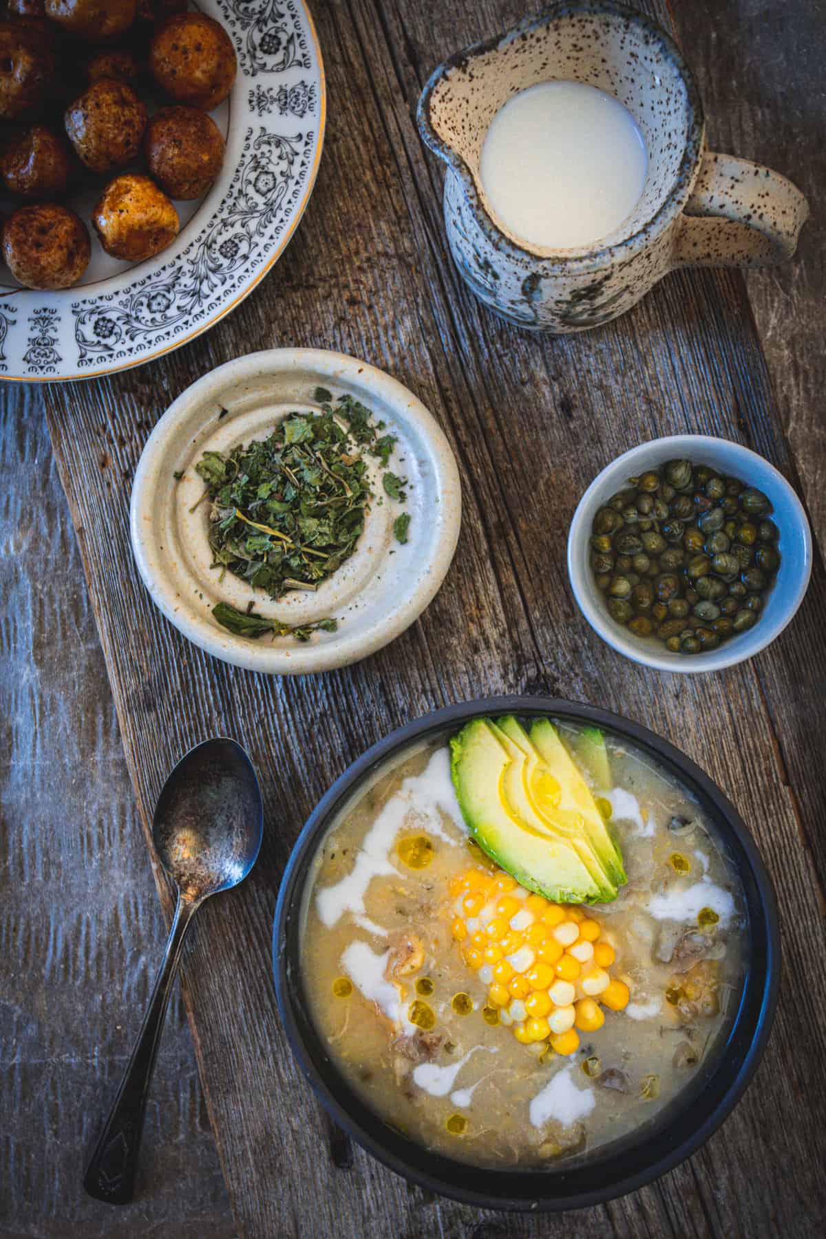 ajiaco bowl with cream, papas criollas and capers