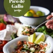 spoon lifting colombian pico de gallo from a bowl