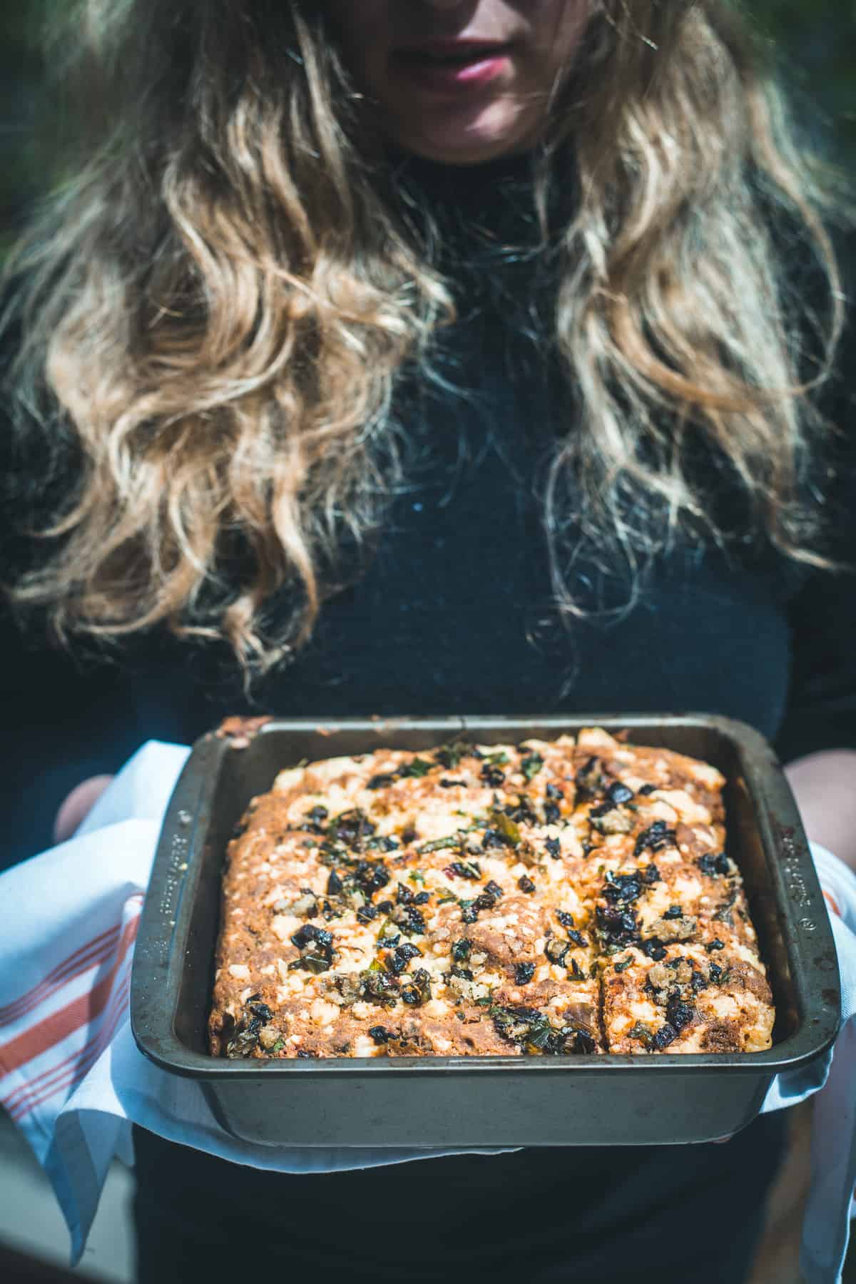 woman holding gluten free cornbread tray