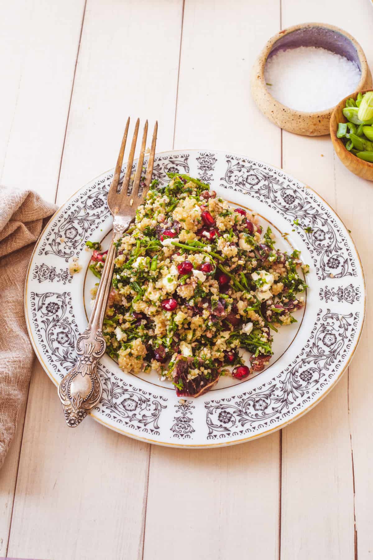 a plate of bulgur salad with a fork and napkin