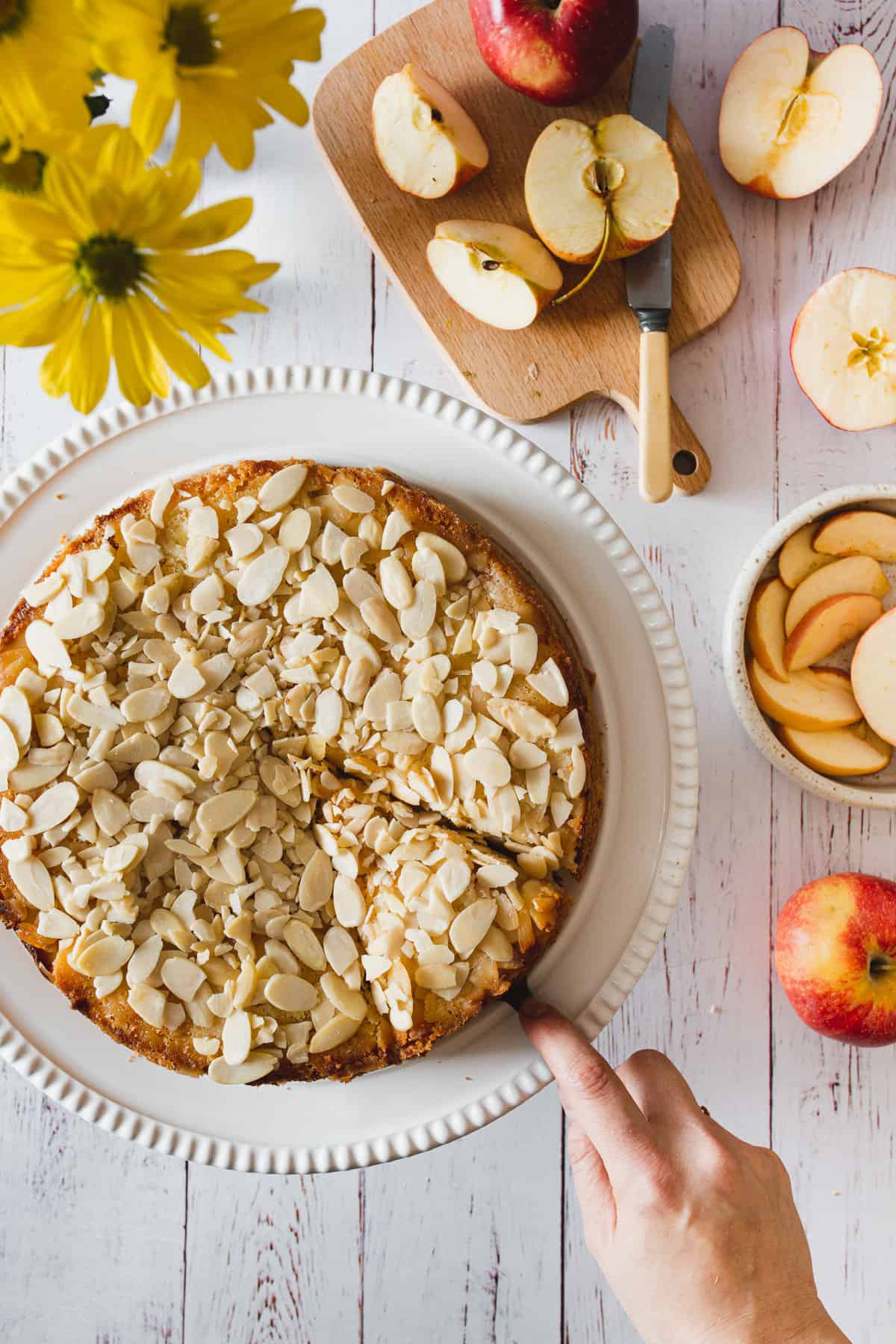 cutting a slice out of gluten free apple cake