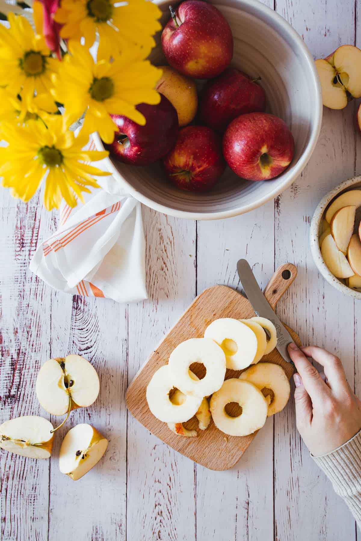 sliced apples on a cutting board with knife