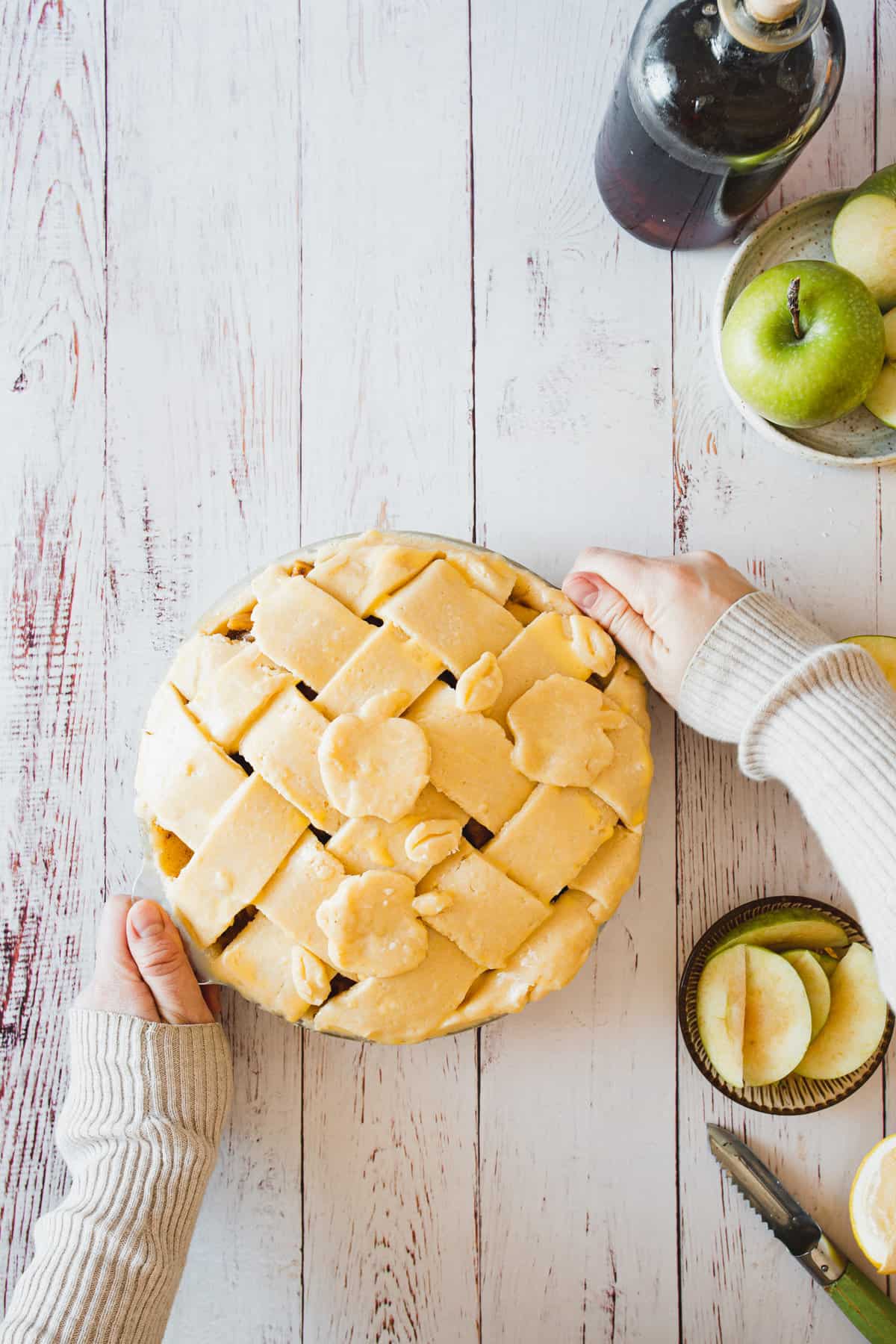 hands holding decorations for gluten free apple pie