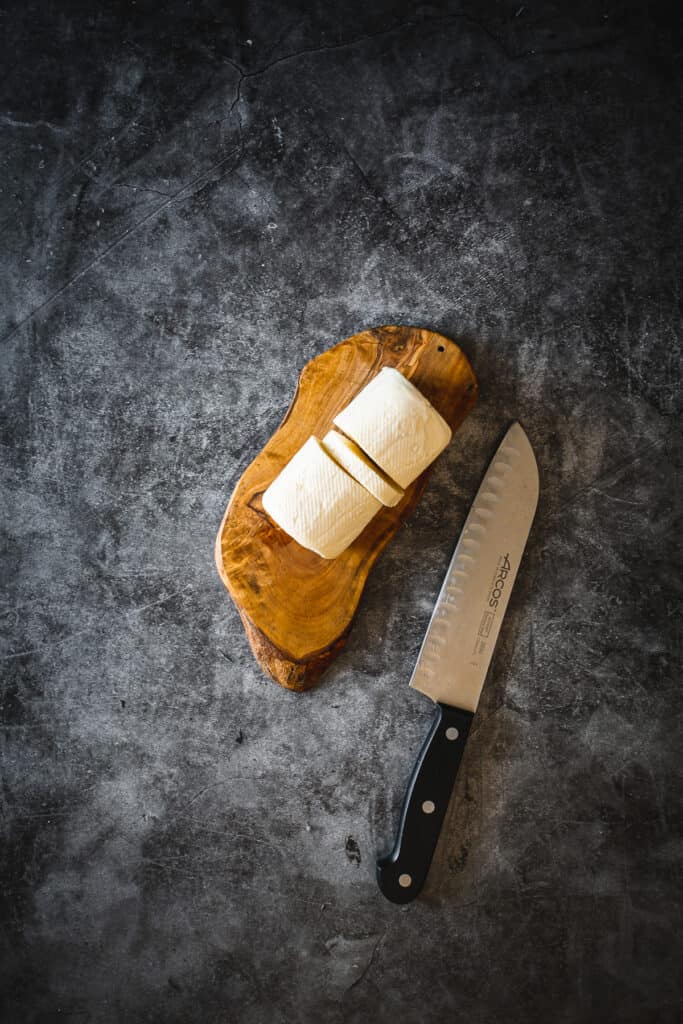 sliced halloumi cheese on cutting board