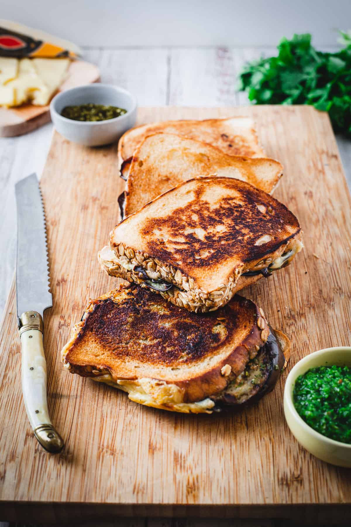 eggplant grilled cheese and knife on board