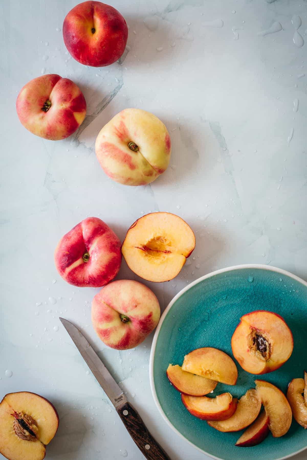 peaches and knife on blue background