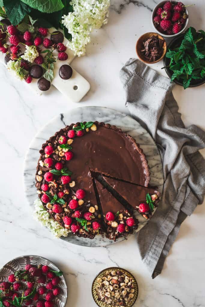 chocolate raspberry tart with two slices cut