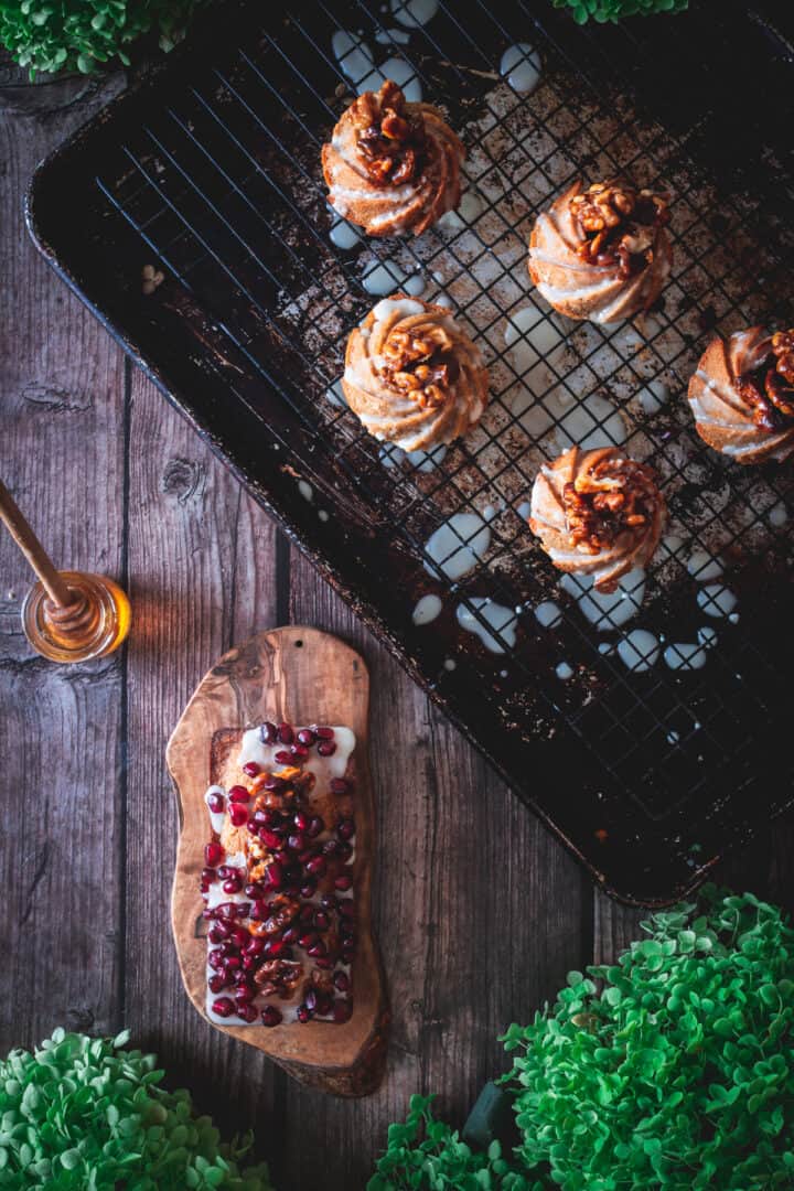 loaf pan cake and mini honey cakes on baking sheet with honey