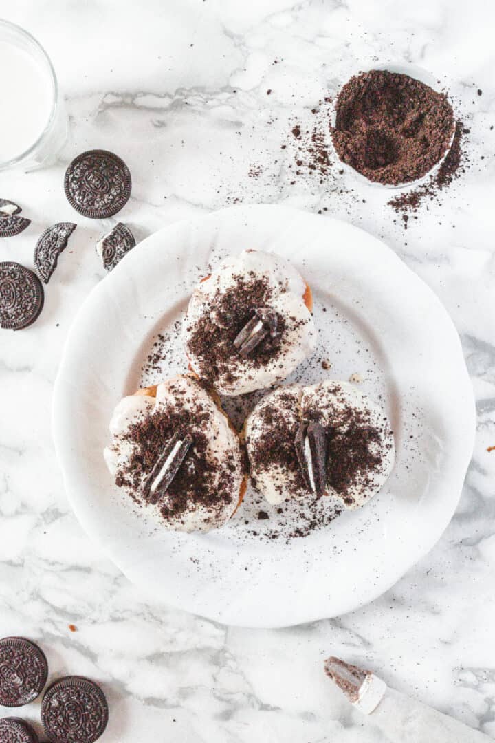 3 Oreo sufganiyot on a plate with ingredients