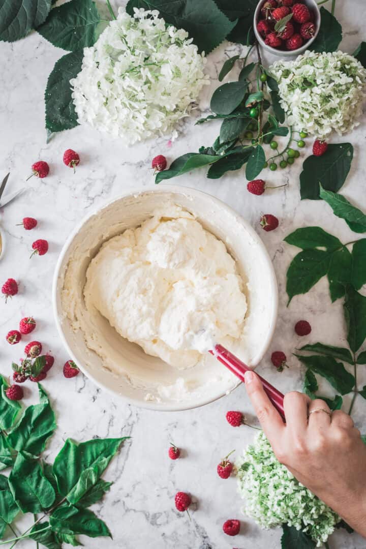 making cheesecake batter in bowl