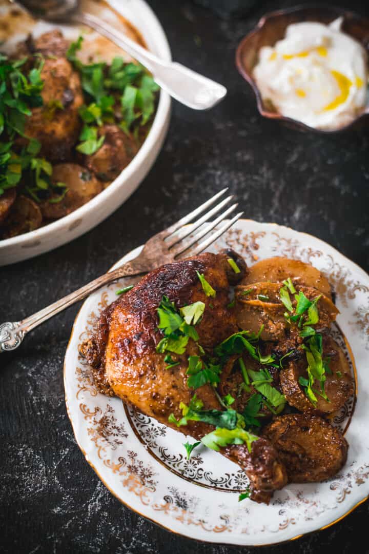 baked buttermilk chicken and potatoes, chicken on a plate and two forks