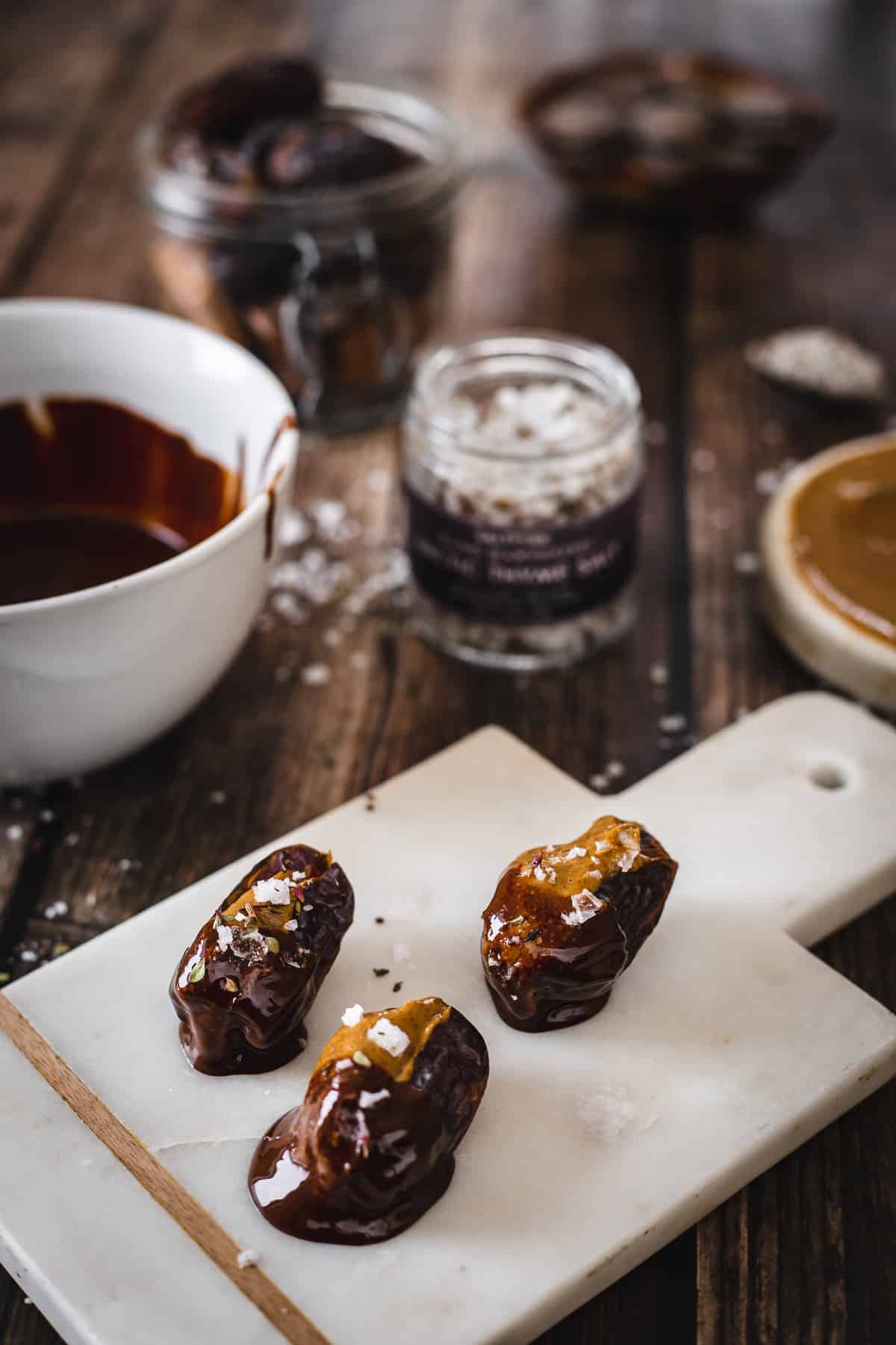 dates stuffed with almond butter dipped in chocolate and sprinkled with salt