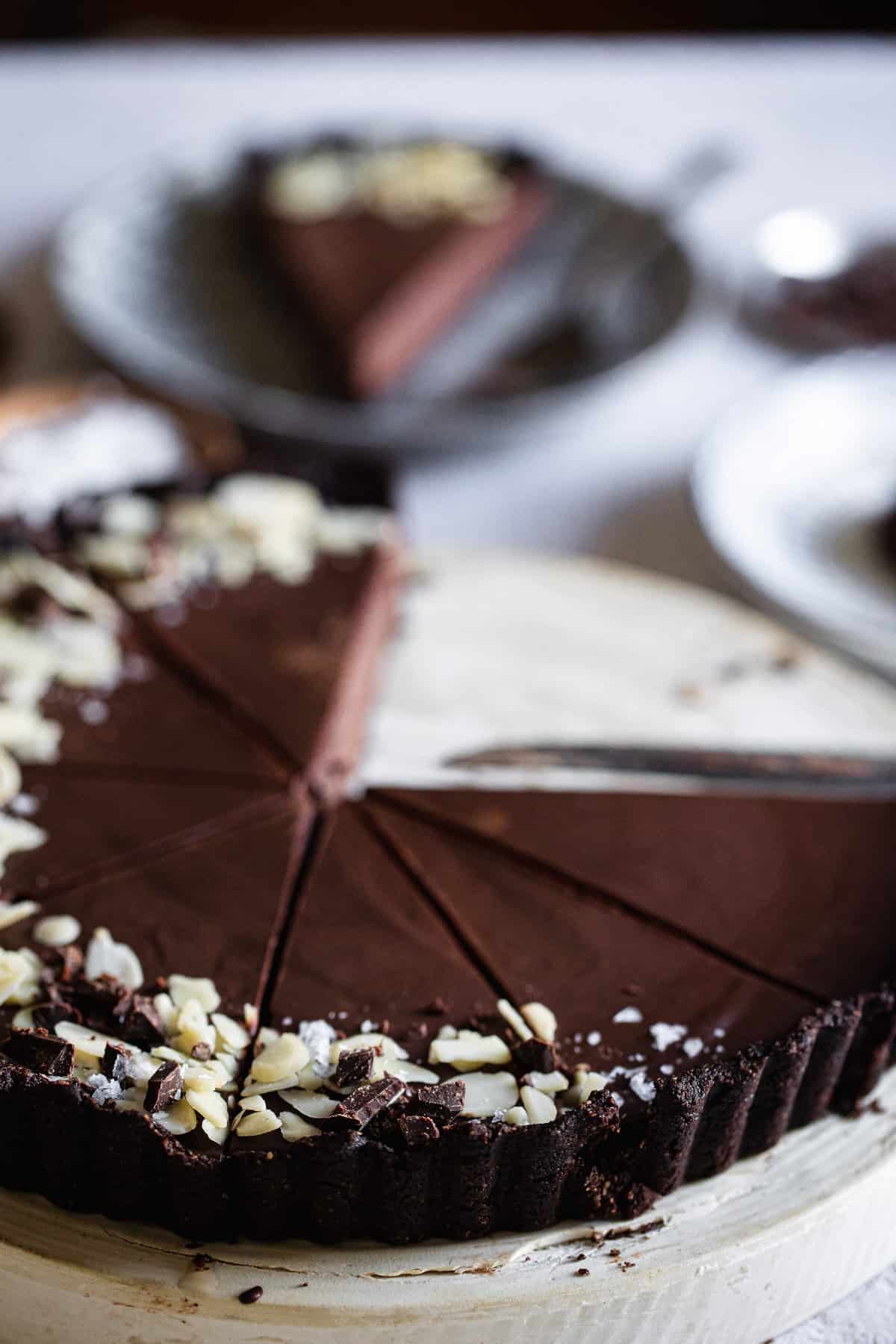 close up of chocolate tart with slice removed