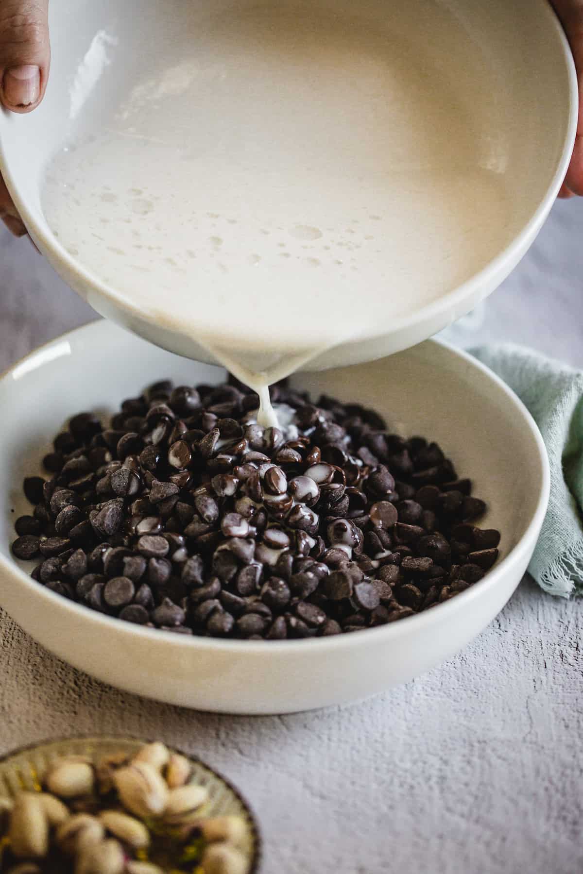 pouring coconut milk on chocolate chips