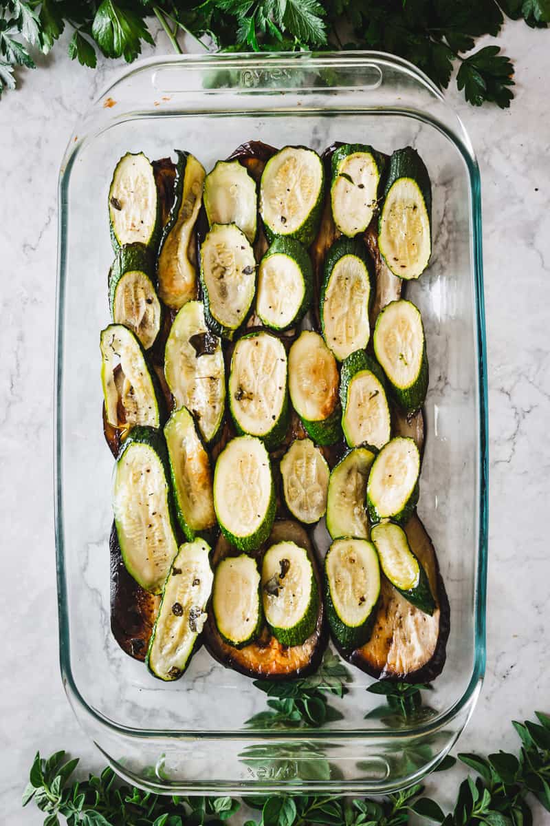 layer of roasted zucchini in a casserole dish