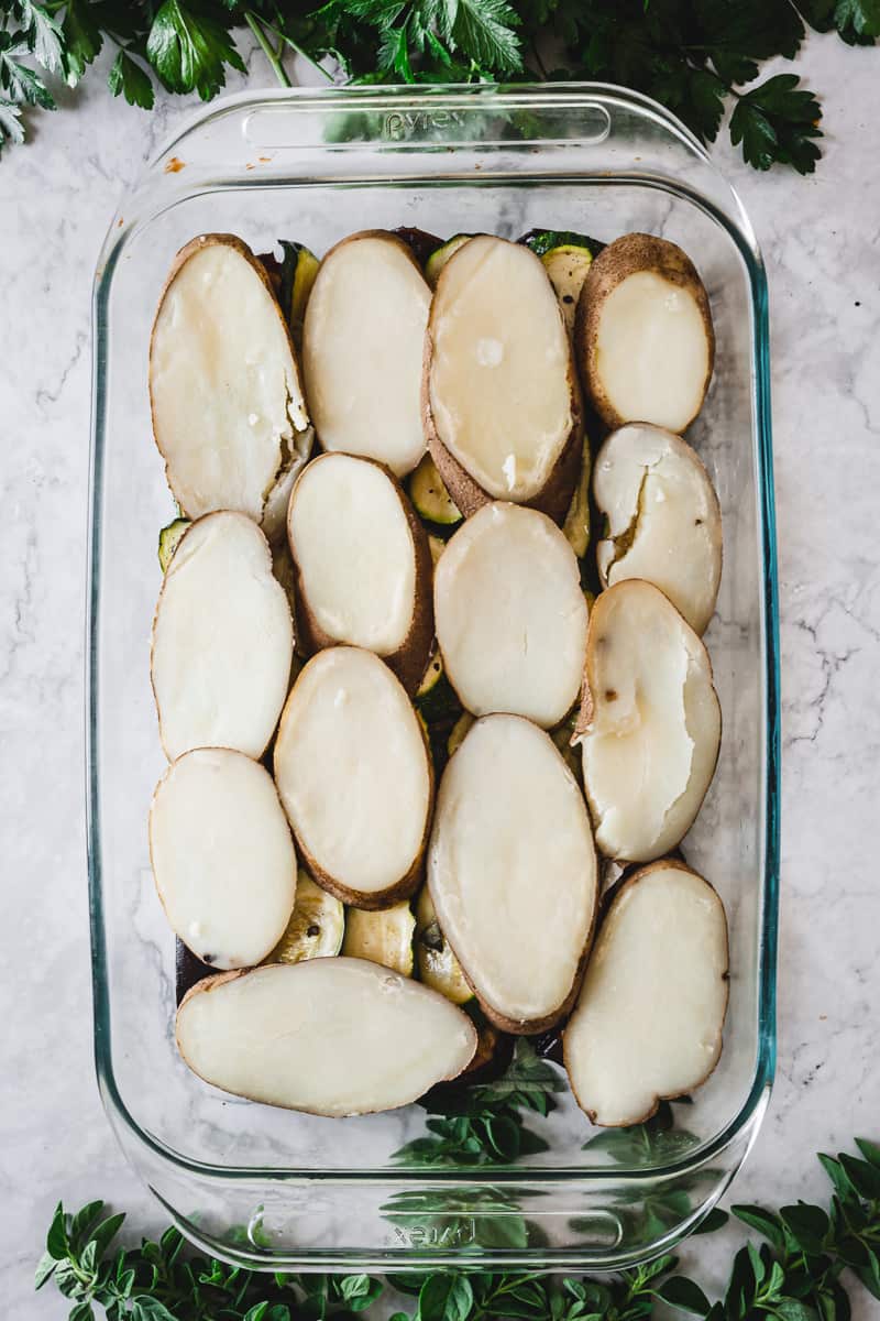 layer of sliced potatoes in a casserole dish