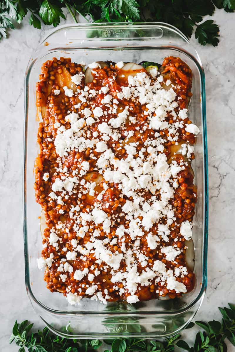 layer of lentils in tomato sauce and feta