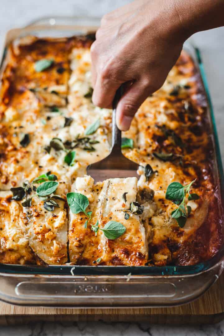 taking out a slice of vegetarian moussaka