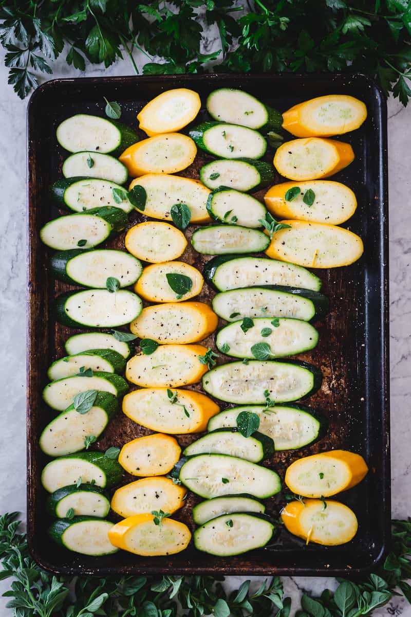 sliced zucchini on baking sheet