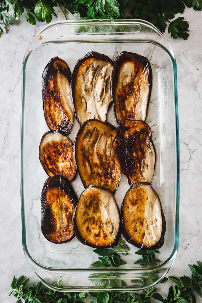 layer of roasted eggplants in a casserole dish