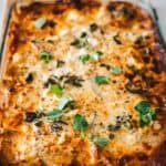 Vegetarian lasagna in a baking dish with sprigs of thyme.