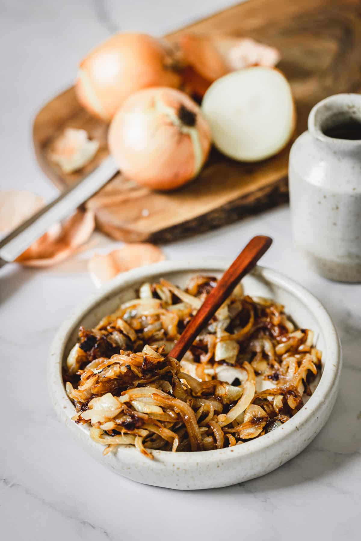 spoon in bowl with caramelized onions
