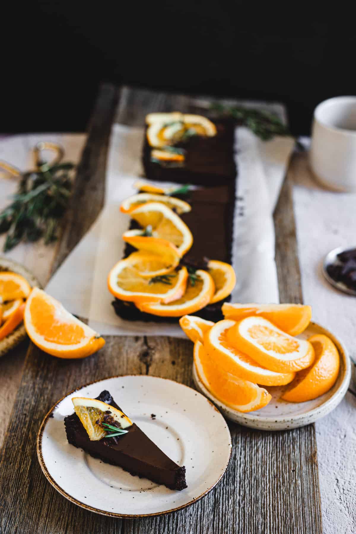 slice of orange chocolate tart with tart behind it