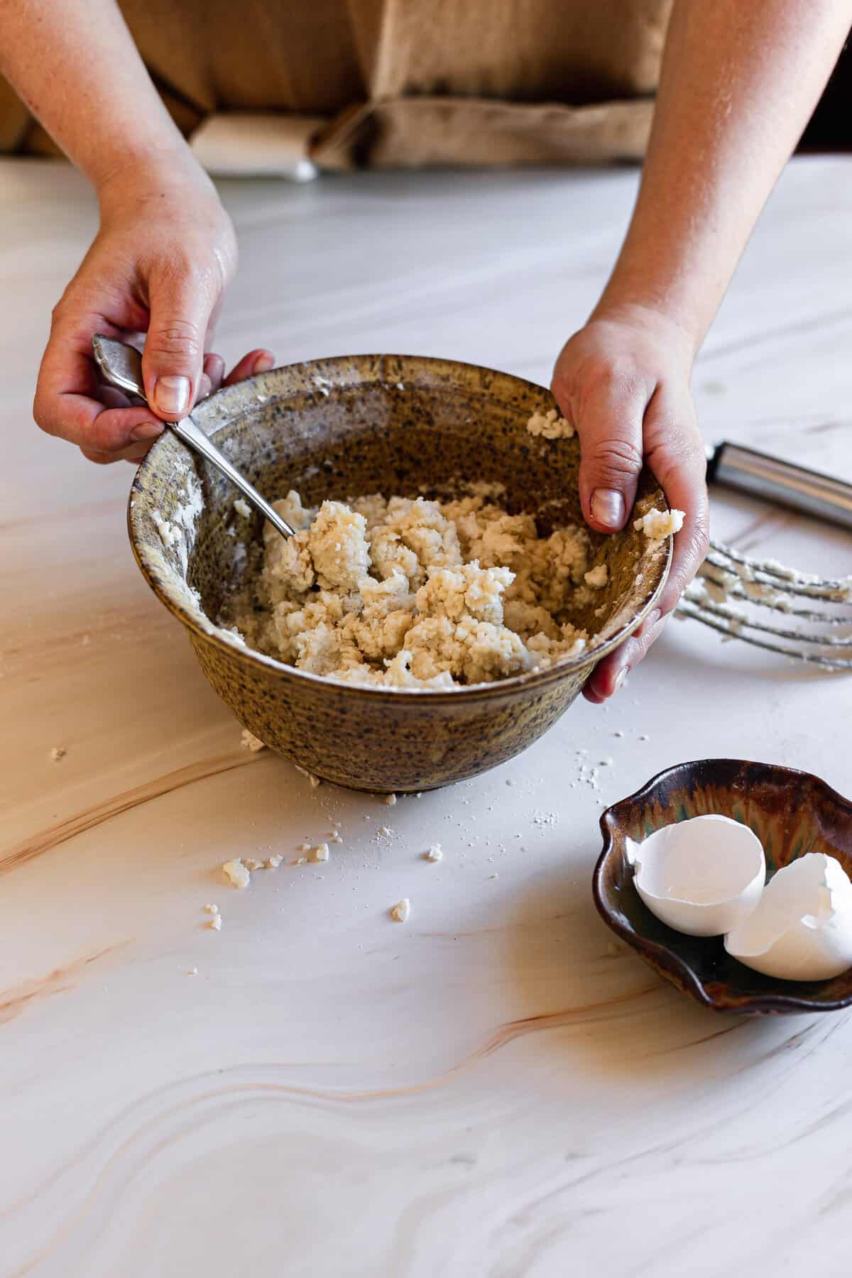 mixing all the ingredients together in a wooden bowl