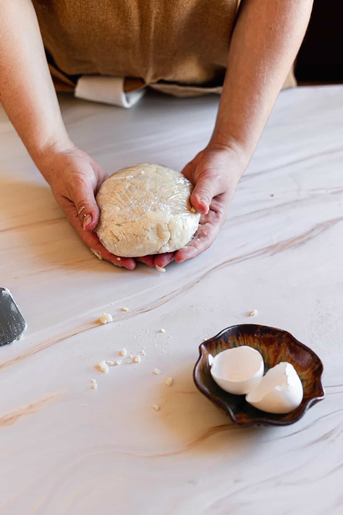 hands holding dough