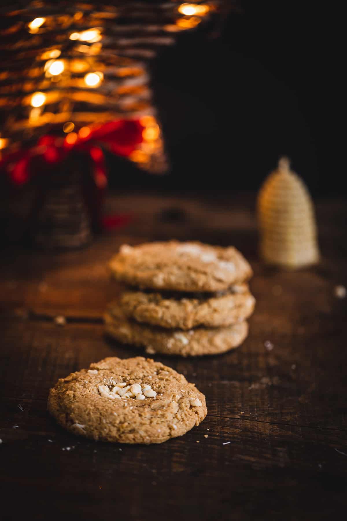cookies on black background with christmas lights and candle