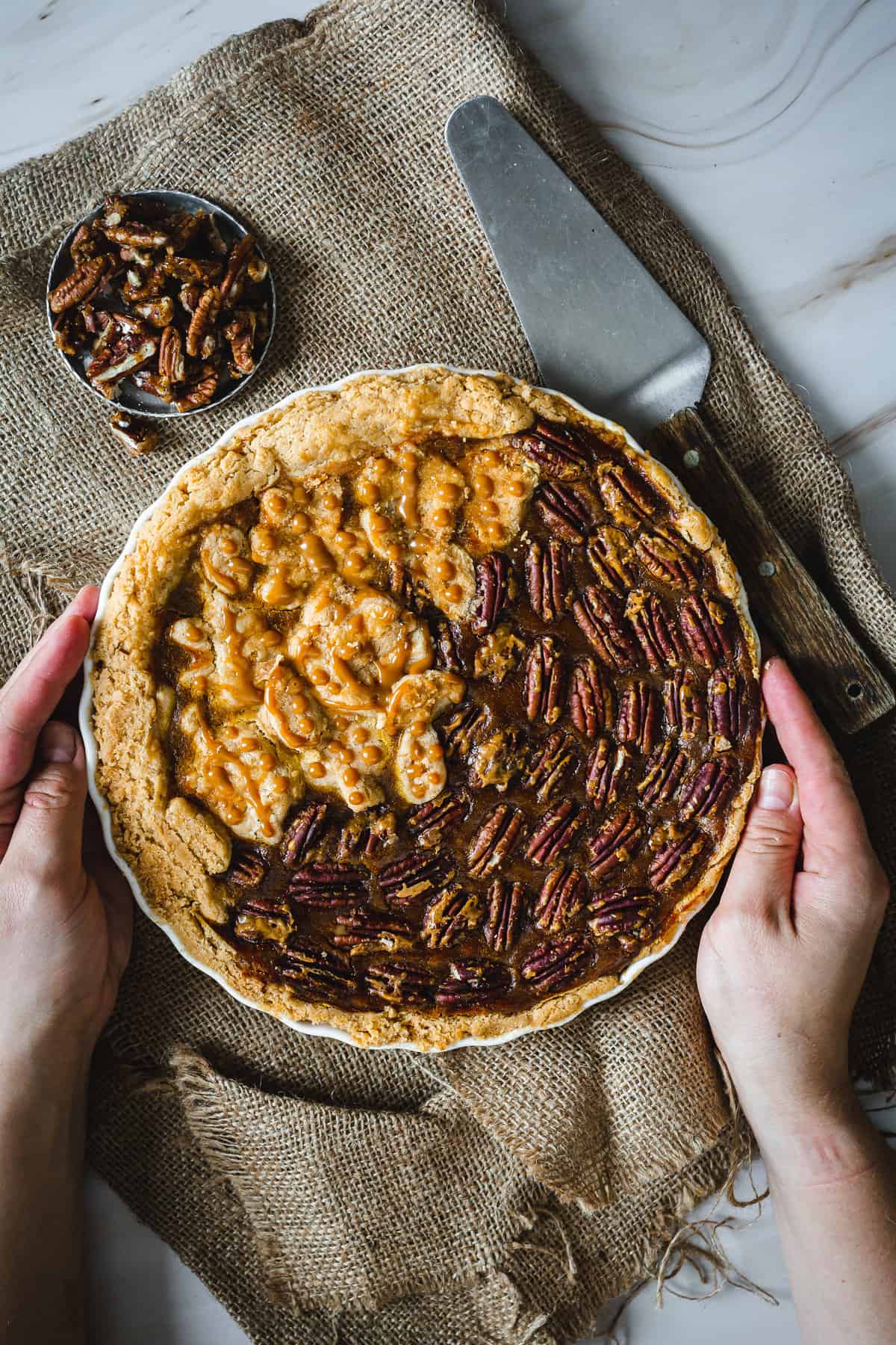 hands holding baked pumpkin pie