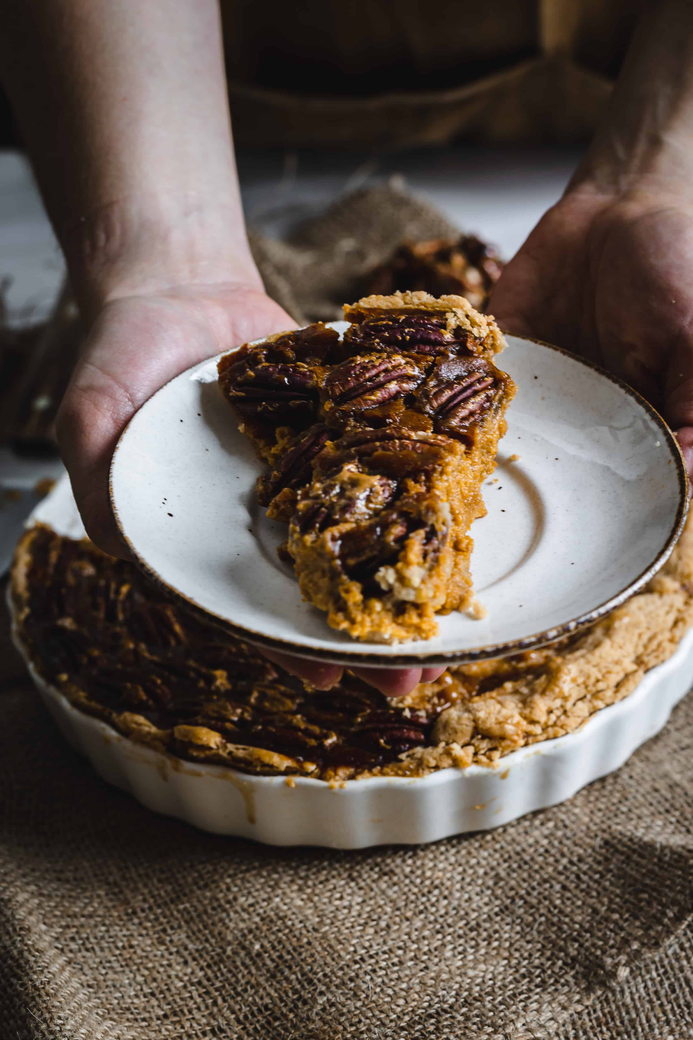 a slice of pumpkin pecan pie on a plate