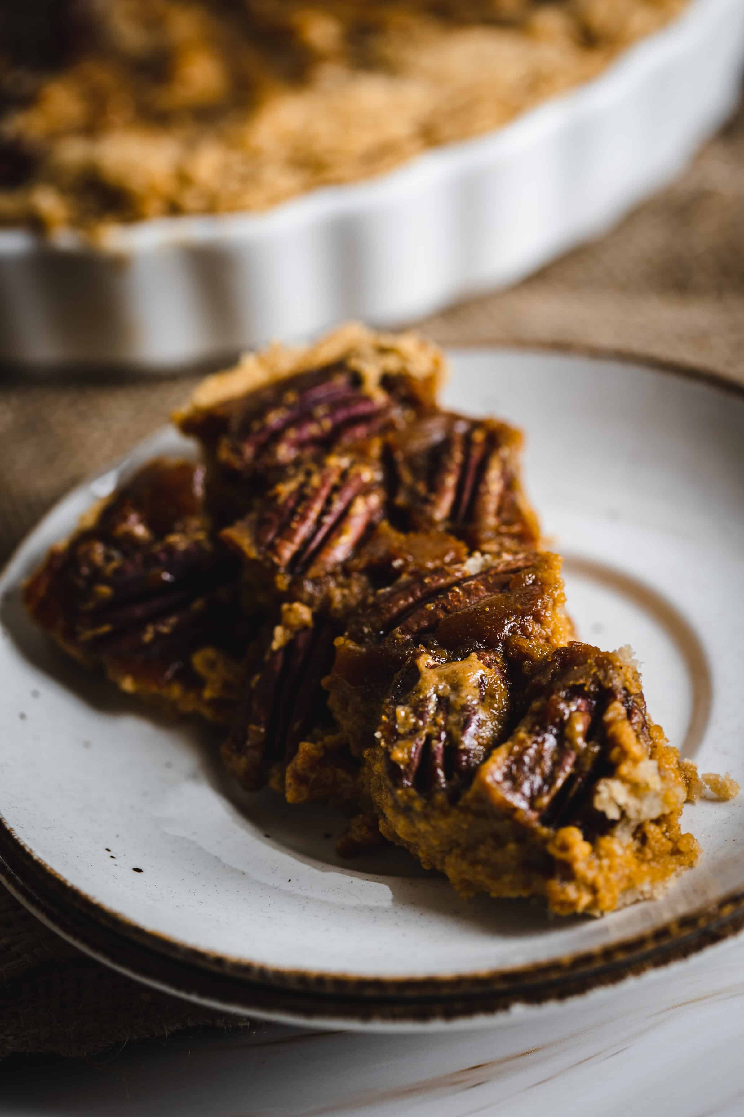 a slice of pumpkin pecan pie on a plate