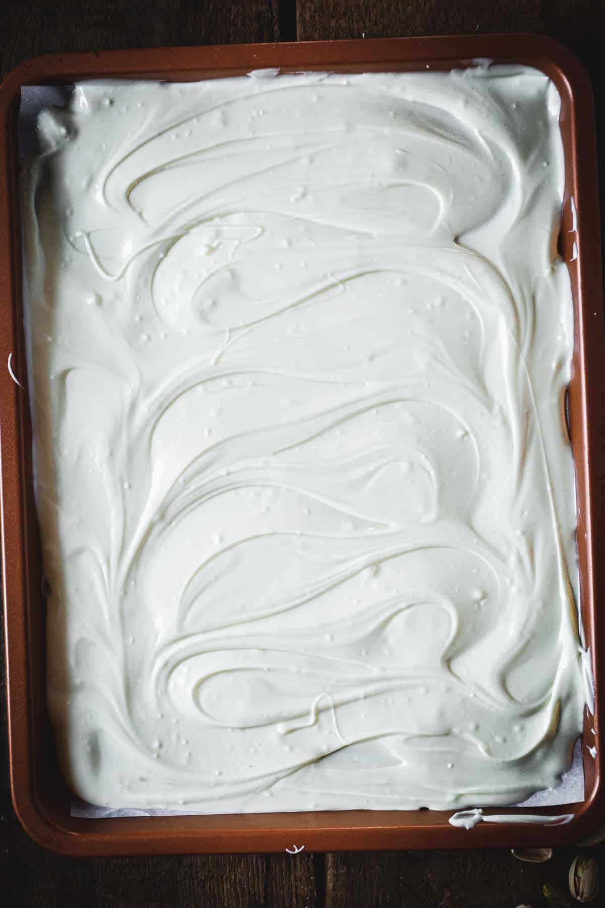white chocolate spread across baking sheet