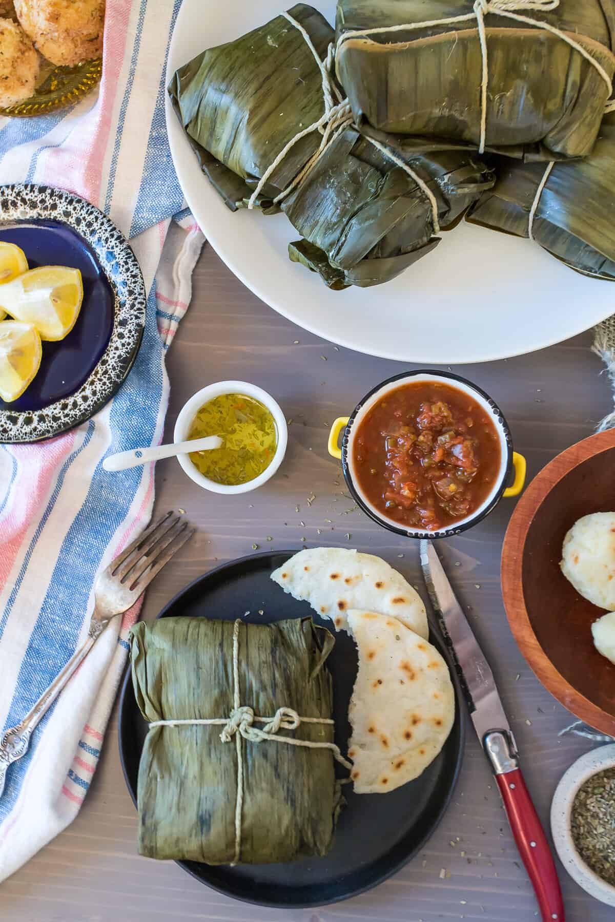 colombian tamales with sauce and arepas
