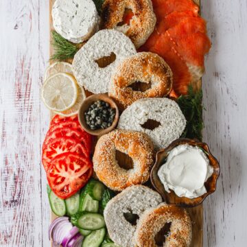 assembled board with veggies lox and bagels