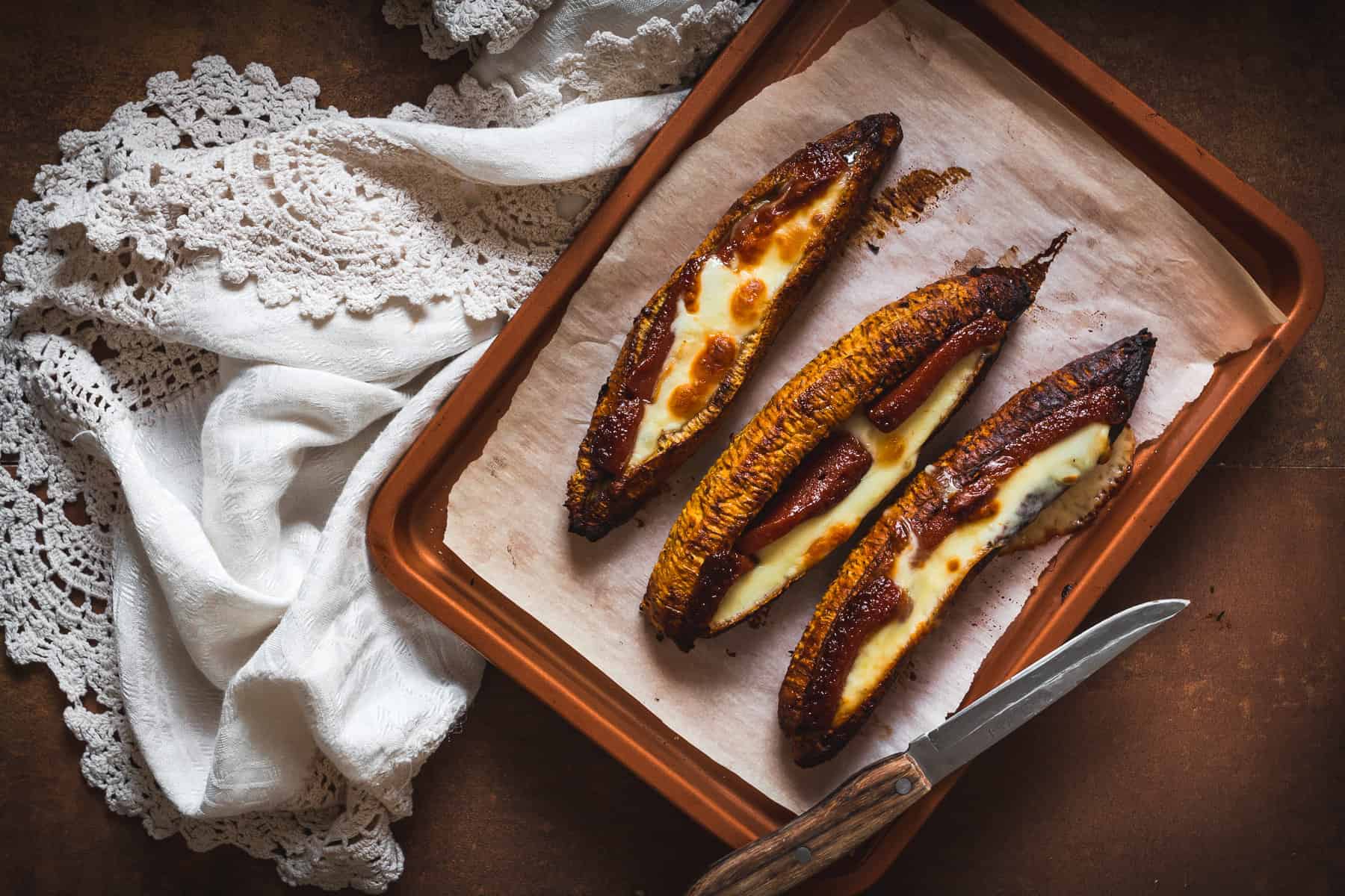 baked plantains on baking sheet with cloth