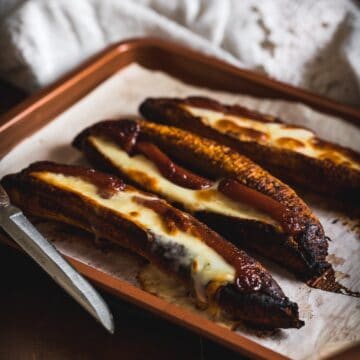 stuffed plantains on baking sheet  Apple olive oil cake Plantains with cheese and guava THUMBNAIL 360x360