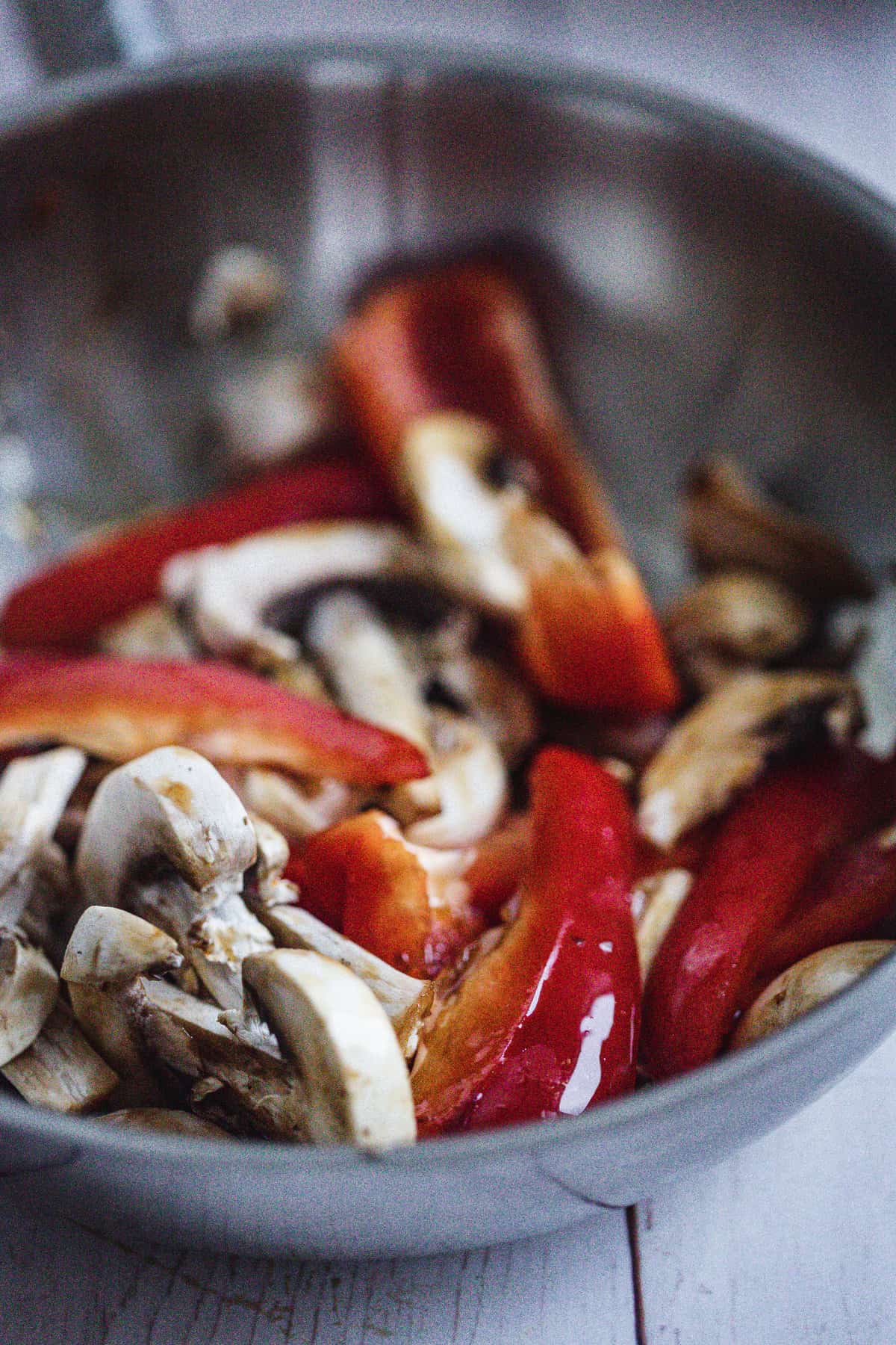 mushrooms and bell peppers in a frying pan