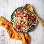 pan fried halloumi salad on a plate with napkin and wooden spoon