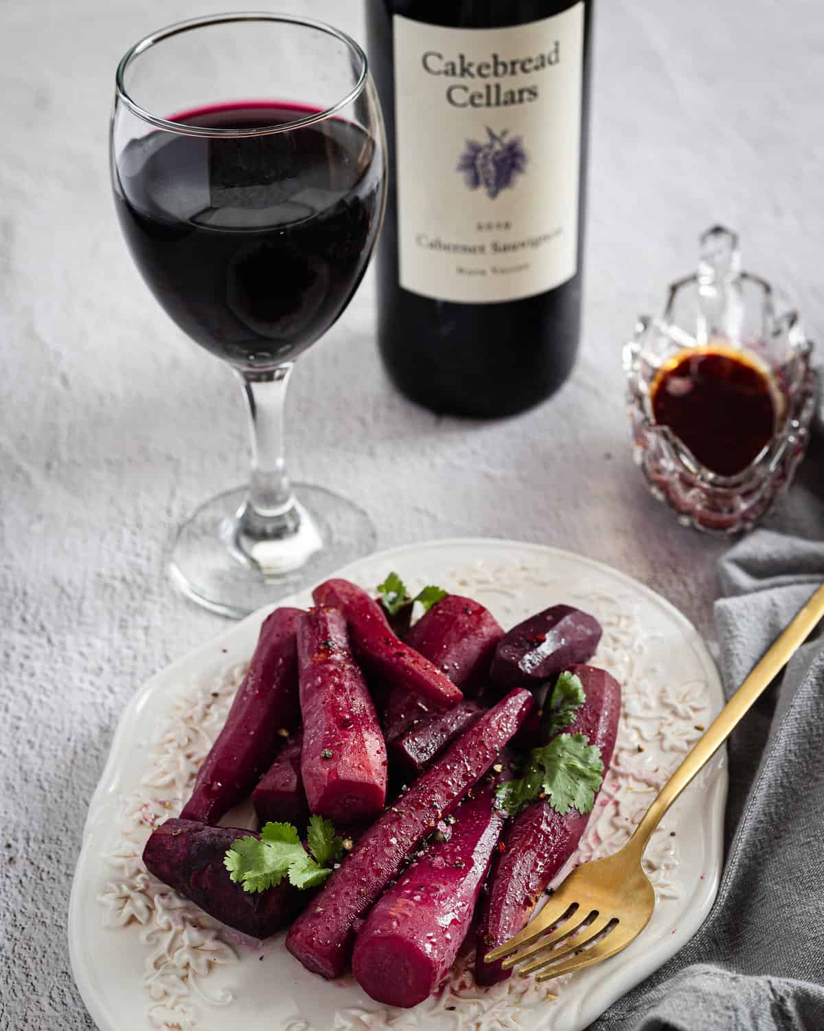 wine glazed carrots with parsley with fork and wine