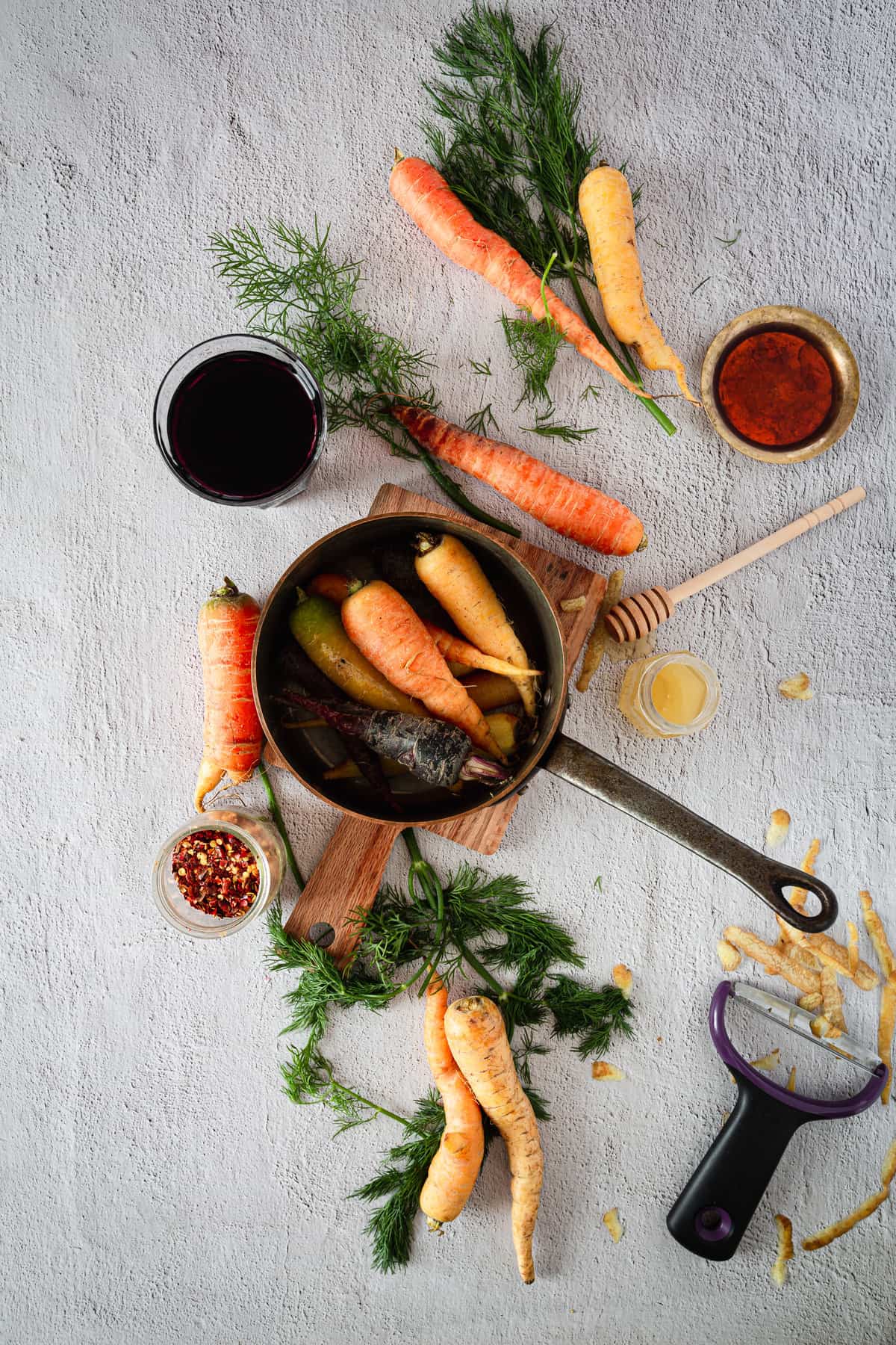 carrots in saucepan with ingredients around
