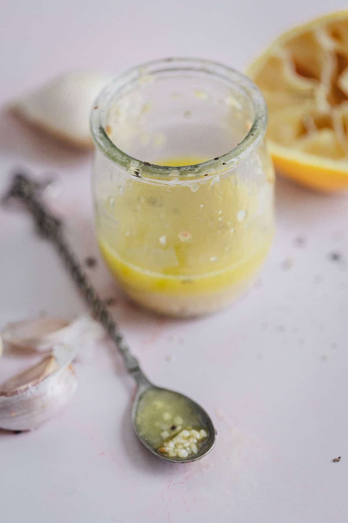 lemon vinaigrette in small jar with spoon