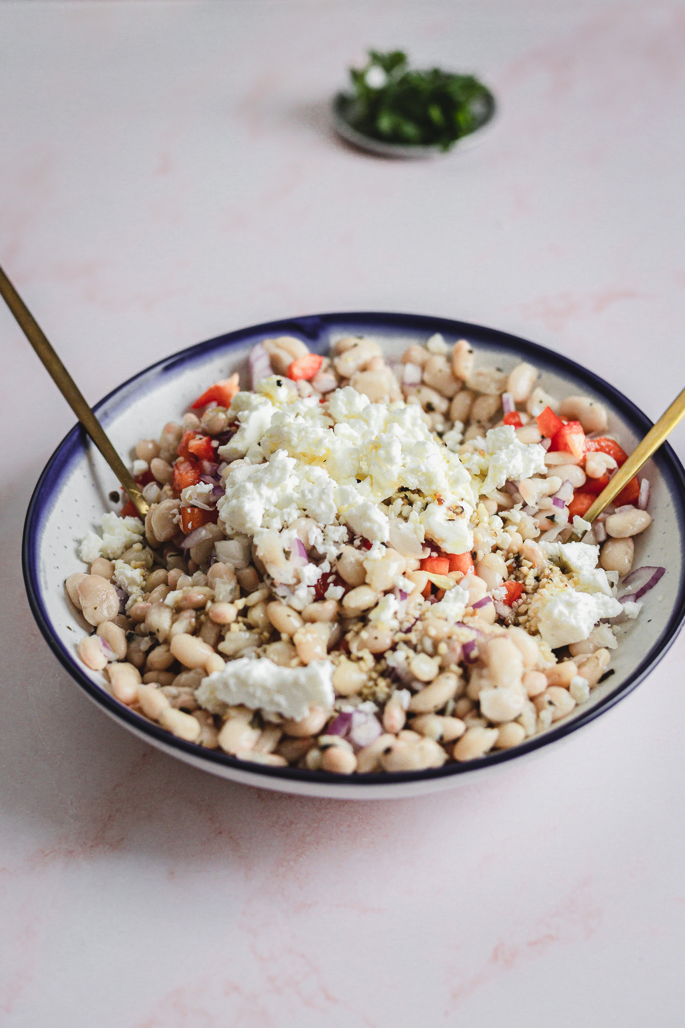 white bean salad with feta and spoons