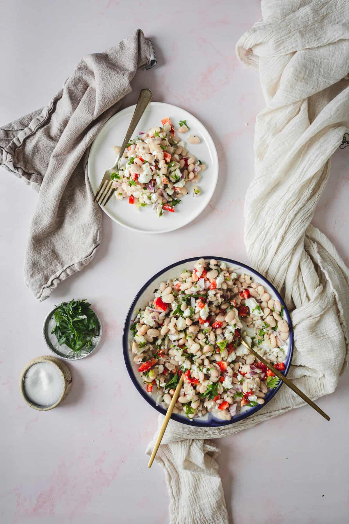 small plate and large serving of white bean salad