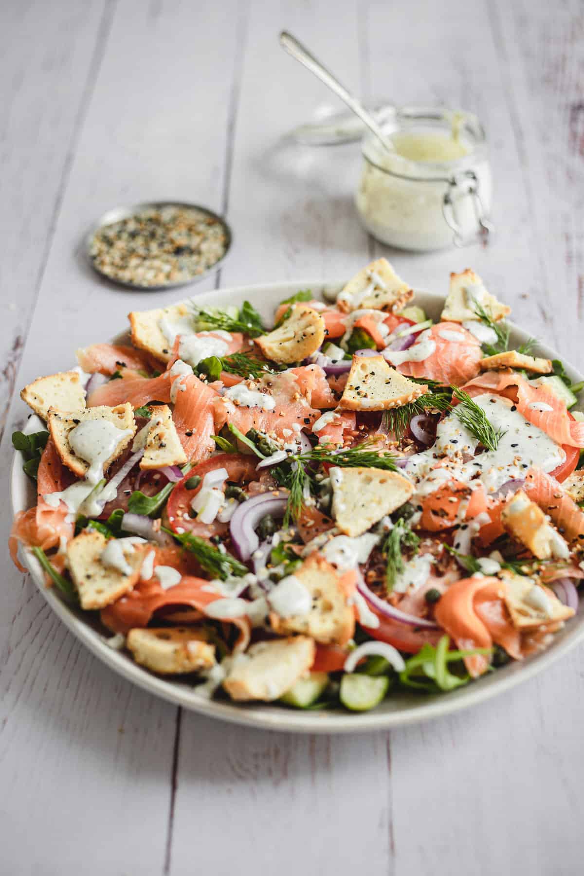 platter of salad with dressing and bagel seasoning